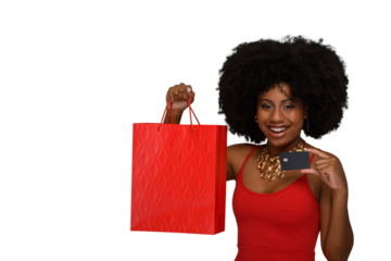 a woman with a shopping bag holds a black credit card and smiles,
