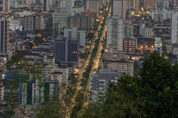 City of Santos, Brazil. Ana Costa avenue illuminated in the early evening. Aerial view of the city.