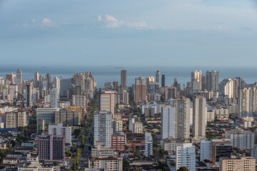 City of Santos, Brazil. Aerial view of the city. Ana Costa avenue on the right crossing the neighborhoods of Vila Mathias, Campo Grande and Gonzaga. In the background the sea and ships on the horizon.