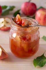 Apple jam in jar on wooden table