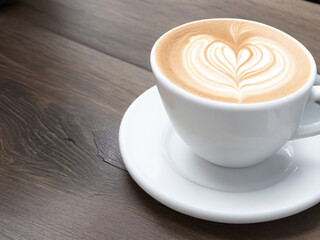 "Cafe Comfort: Enjoy a Perfect Cup of Cappuccino or Flat White in a Cozy Coffee Shop - White Cup on Rustic Wooden Table"