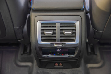 Close-up view of rear dual-zone climate control of new car. 