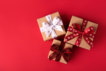 Christmas gift boxes with red balls on red background.