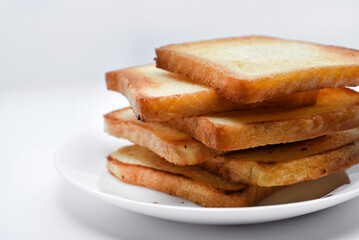 Fried toast on a white plate. Baked bread for sandwiches. Vegan food.