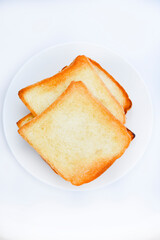 Fried toast on a white plate. Baked bread for sandwiches. Vegan food.