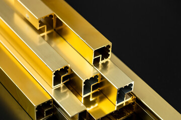 Golden aluminum profiles, gold color, black background, copy space