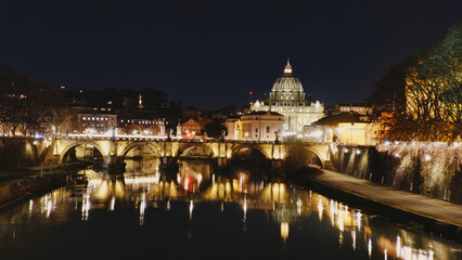 Fototapeta na wymiar Vatican City, Rome, Italy, Beautiful Vibrant Night image Panorama of St. Peter's Basilica, Ponte Sant Angelo and Tiber River at Dusk in Summer. Reflection of The Papal Basilica of St. Peter