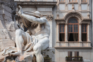 Close-up detail of biblical figure in Bernini's sculpted Baroque Fountain of the Four Rivers in Piazza Navona, a popular tourist landmark in the historic old town of Rome, Italy.