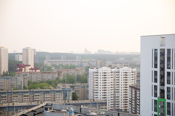 Fototapeta na wymiar smog smoke over town. city panorama, houses, buildings. smoke from summer forest fires, bad ecology