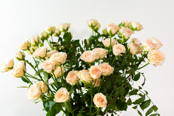 A bouquet of delicate cream roses close up, home decoration with flowers, a festive bouquet of roses for a birthday or wedding