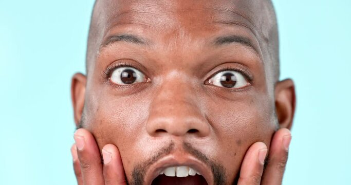 Face, wow and a black man with big eyes on a blue background for news, deal or announcement. Closeup, surprise emotion and portrait of a shock facial expression of an excited African crazy person