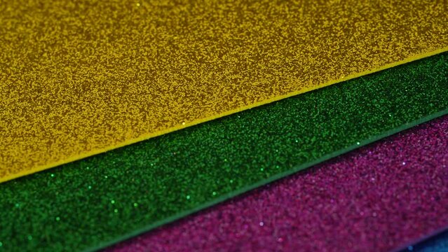 New year decorative yellow, green, purple and blue gift paper with blinking points turning slowly around. High quality 4k footage