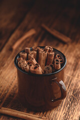 Cinnamon sticks in a metal mugr