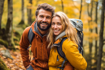 Fototapeta premium Happy couple piggybacking in a forest in autumn, showcasing love