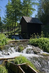 Jaice, Bosnia and Herzegovina - Sep 11, 2023: Mlincici watermills on the Pliva lake in Jaice. Wonderful landscapes in Bosnia and Herzegovina. Sunny day. Selective focus.