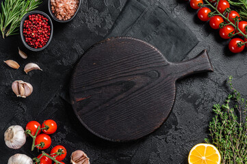 Ingredients for cooking and empty cutting board on old wooden table, Food cooking and healthy eating background. Black background. Top view. Copy space