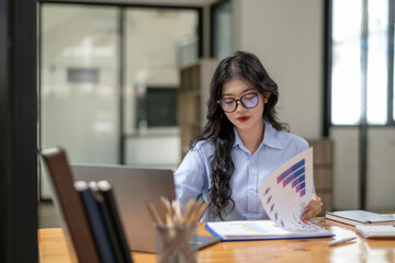 Young businesswoman working on laptop. Marketing Audit. Follow economic news