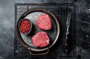 Foto auf Acrylglas Antireflex Dry aged Raw steaks fillet Mignon, Beef tenderloin. Black background. Top view © Vladimir