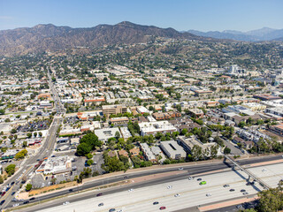 Glendale, California – September 9, 2023: drone view toward Glendale CA with 134 freeway and Glendale downtown buildings, apt, houses, homes