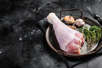 Uncooked turkey legs Drumsticks, raw Poultry meat. Black background. Top view. Copy space