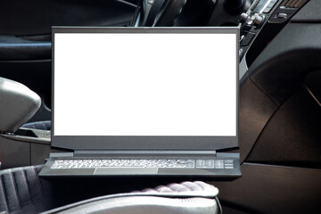 A laptop with a white screen stands on the seat in the car, work and business trip, space for text...