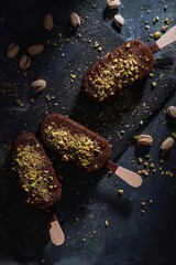 Three pistachio and chocolate ice cream stick