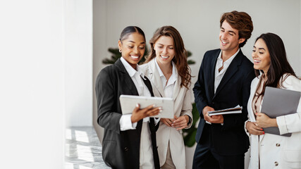 Business discussions. Young international colleagues using digital tablet during meeting in office, panorama, free space