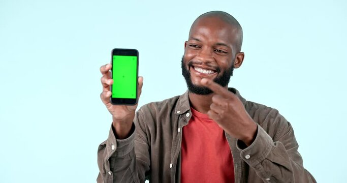 Pointing, green screen or happy black man with phone discount deal or sale on logo space. Advertising, smile or face of African person with mockup, news or mobile app promotion on blue background