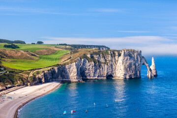 Etretat, Normandy France, the Beach, Needle and Aval Arch, on a fine summer afternoon. - obrazy, fototapety, plakaty