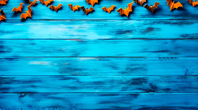 Blue wooden background with orange bats on the top and bottom of it.
