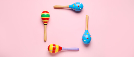Frame made of Mexican maracas on pink background