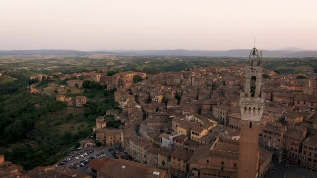 Aerial of old town Siena skyline and city center at sunset in Tuscany, Italy 9