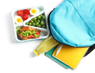 Backpack, stationery and lunchbox with yummy food isolated on white background