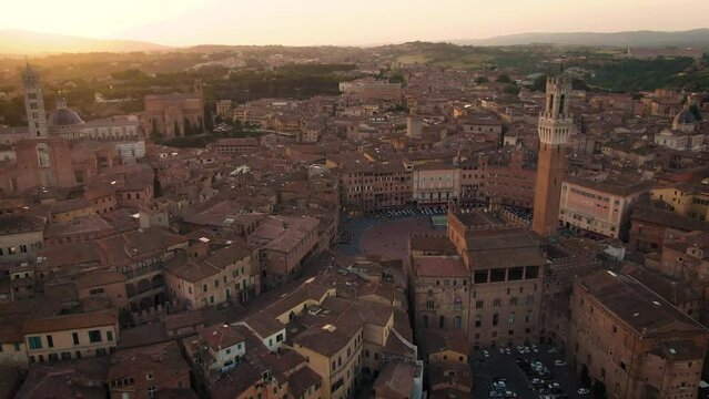 Aerial of old town Siena skyline and city center at sunset in Tuscany, Italy 7