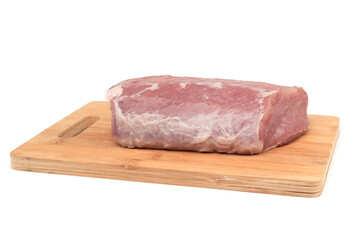 Piece of raw pork meat on a wooden cutting board over a white background.