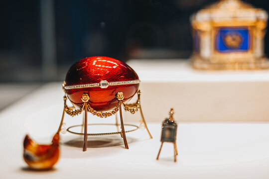 Decorative ceramic golden red Fabergé egg with jewelry snake, it's a jewelled egg created by the jewellery firm House of Fabergé, in Saint Petersburg, Russia.
