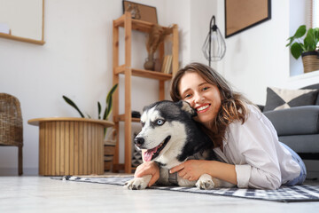 Happy young woman with husky dog at home © Pixel-Shot