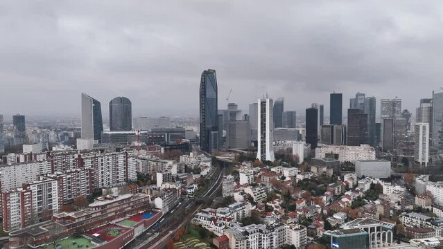 On a cloudy day, Paris's La Défense district exudes an urban charm.
