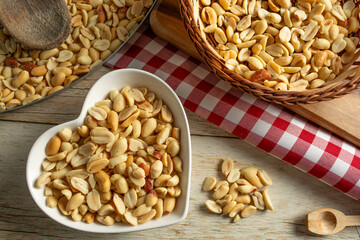 top view shelled and salted roasted peanuts over wooden table