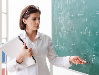 Female math teacher in front of the chalkboard