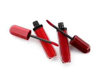 Modern red lipsticks with brushes on white background