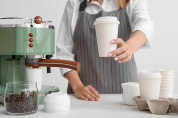 Woman with takeaway cup of hot coffee on white background