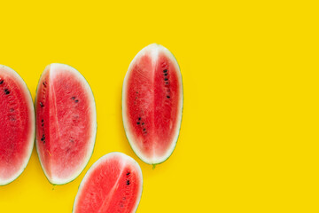 Watermelon slices on yellow background.
