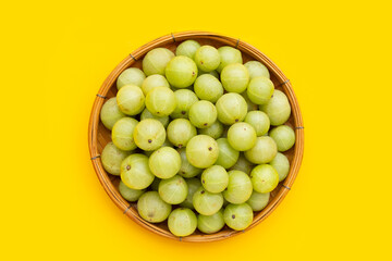 Fresh emblica on yellow background.