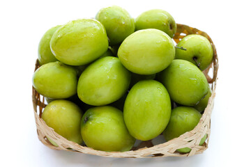 Green jujube fruits on white background.