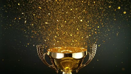Super Slow Motion. Champion Golden Trophy with Exploding Gold Glitters and Stars against black background. Concept of Success, Victory or Achievement.