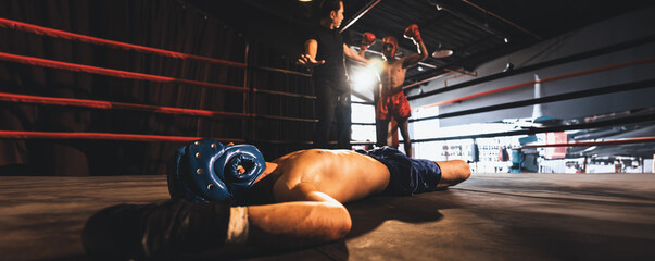 Boxing referee intervene, halting the fight to check fallen competitor after knock out. Referee...
