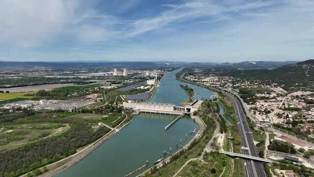 Aerial vista: Donz&egrave;re-Mondragon Dam, a historic powerhouse of hydro, wind, and solar energy