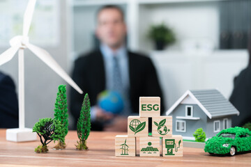 ESG symbol on wooden cube arranged for alternative clean energy utilization and implementation in...