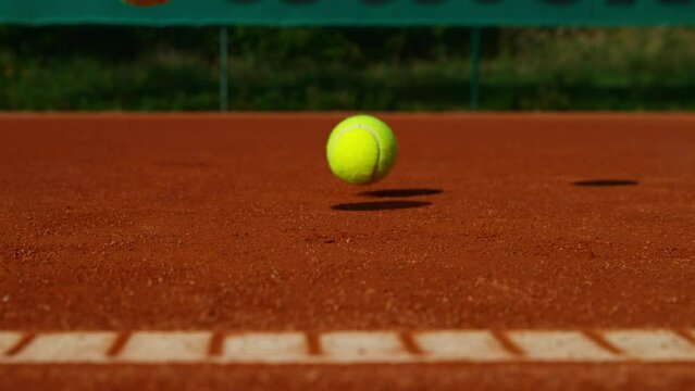 Super Slow Motion Shot of Tennis Ball Hitting a Clay Court Line at 1000fps.